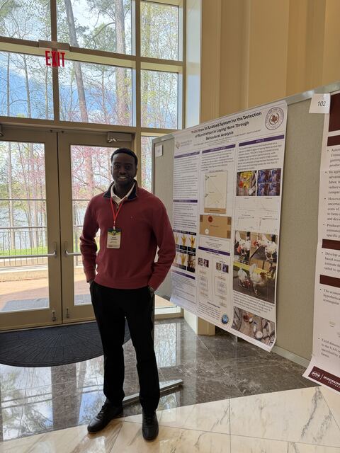 Daniel standing beside his research poster at the AI in Agriculture conference