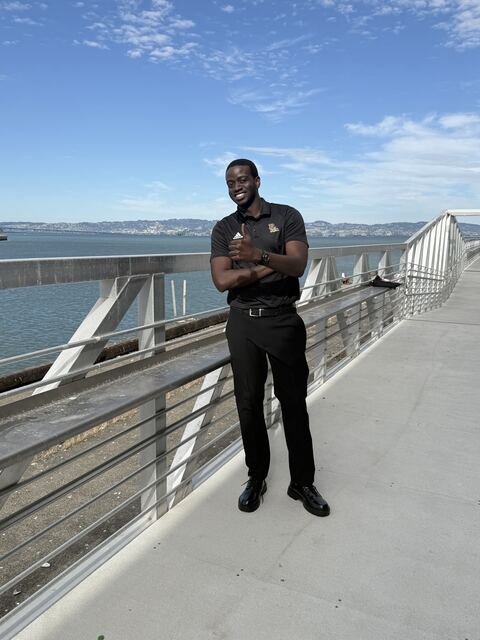 Daniel on the waterfront with the San Francisco bay behind him