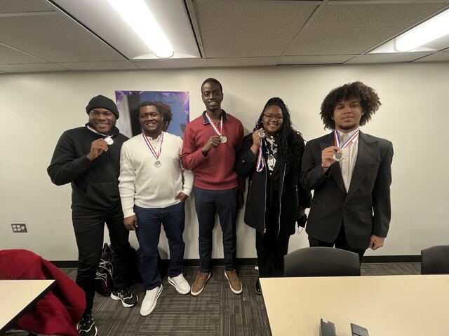 The five-person Waste Wiz team wearing their medals